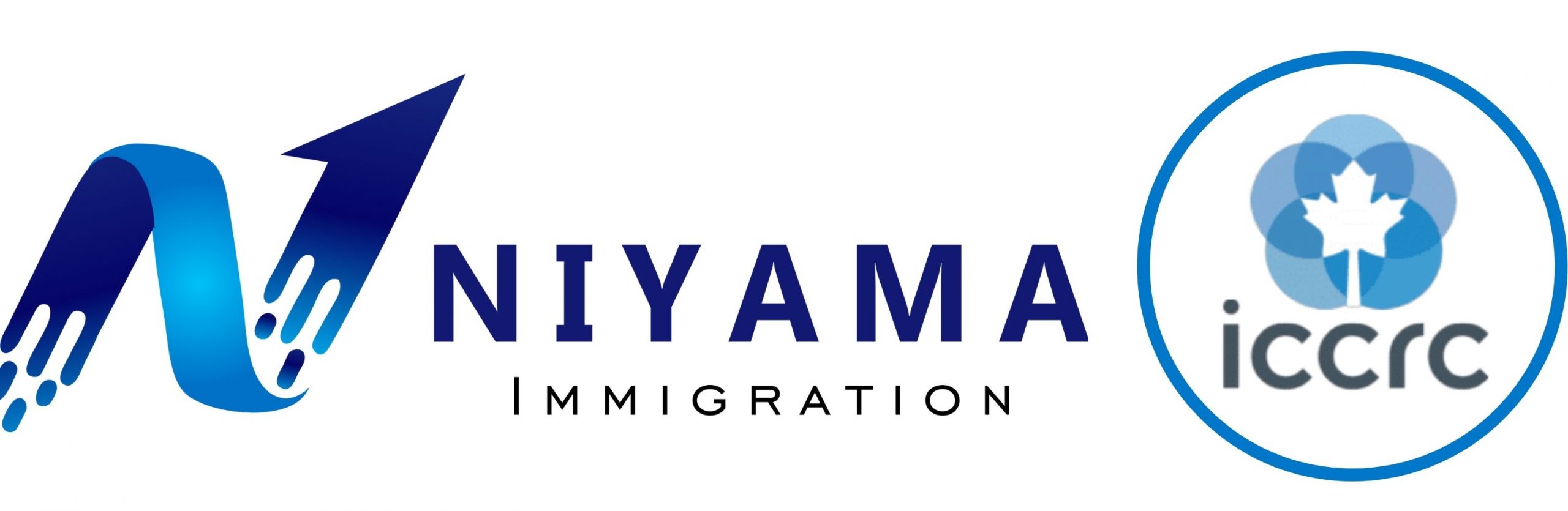 A person smiling while talking on the phone at a desk