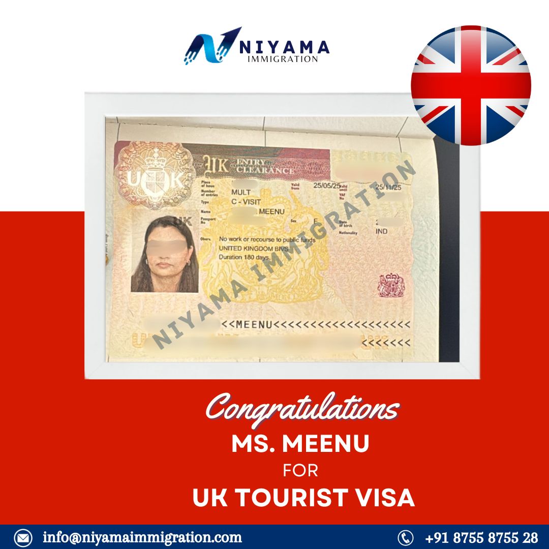 A person smiling while holding their passport with a new visa