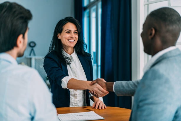 A group of smiling, diverse students standing together on a university campus